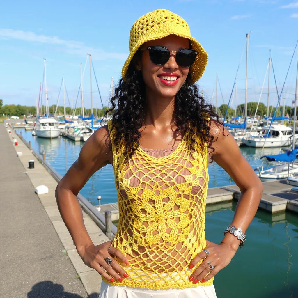 Haut au crochet Narcisola de Cachalabibi vue d'une femme chapeautée dans une marina