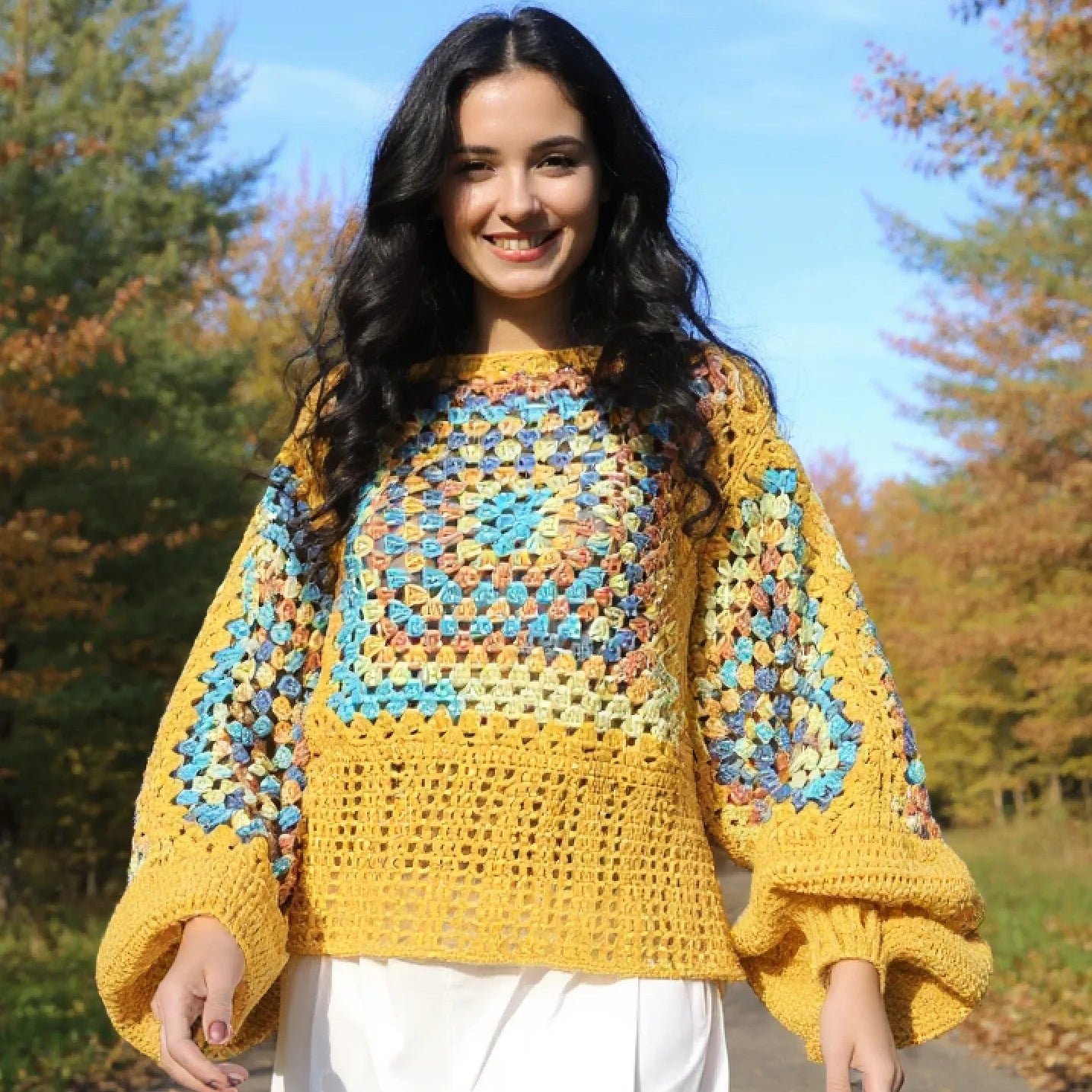 Pull au crochet Labyrintho de Cachalabibi - vue de face sur une femme qui marche sur un chemin forestier